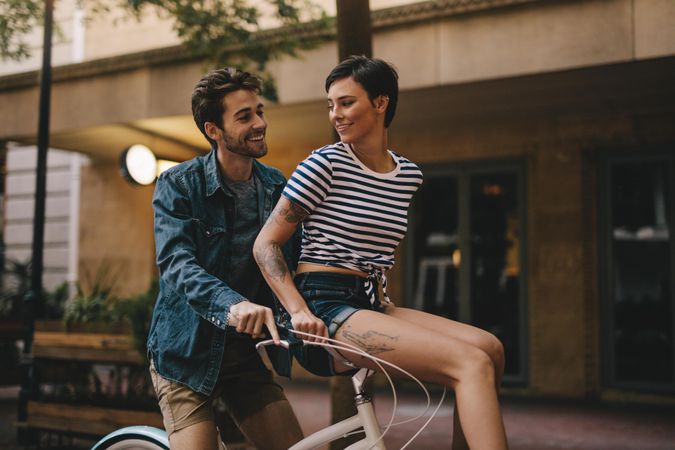 Romantic couple enjoying bicycle ride in the city
