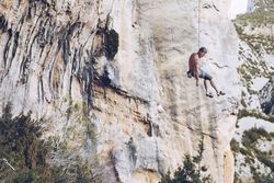 Anonymous climber handing on cliff