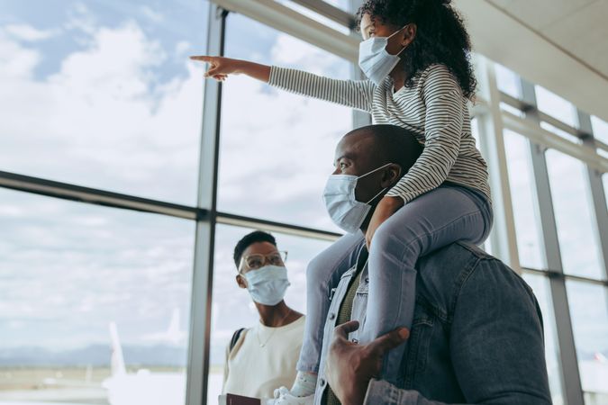 Family going for boarding their flight at airport during pandemic