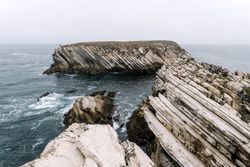 Rocky formations in the island of Baleal on the Atlantic coast in a foggy day. Peniche, Portugal