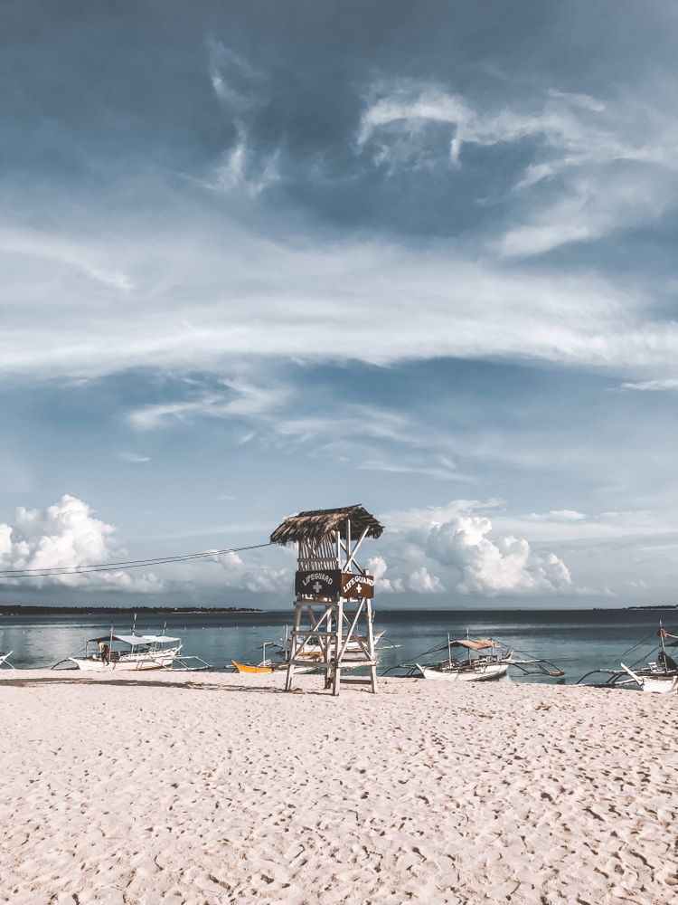 Brown wooden lifeguard stand on beach