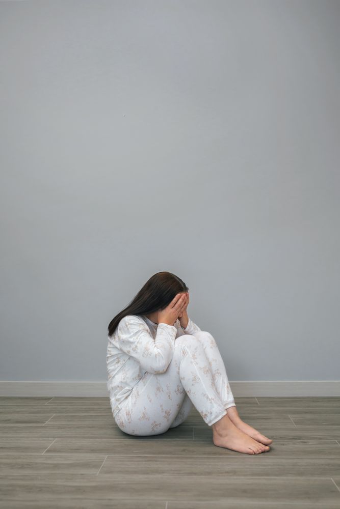 Woman covering her face with hands