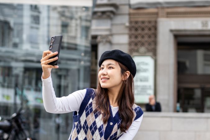 Young Asian woman using smartphone in the city