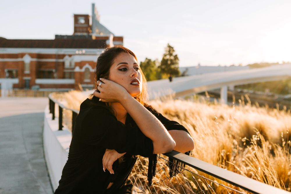 Trendy female standing on urban background