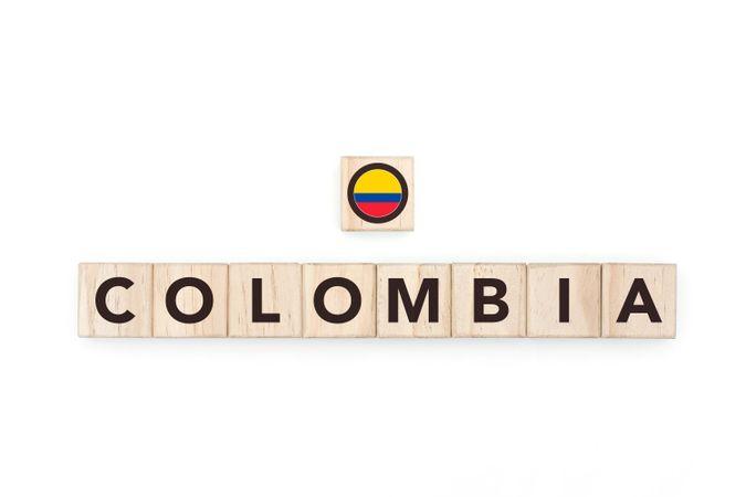 Wooden blocks bearing the name and flag of Colombia. Colombian and South American Culture, national identity, travel, and geography in a copy space design.