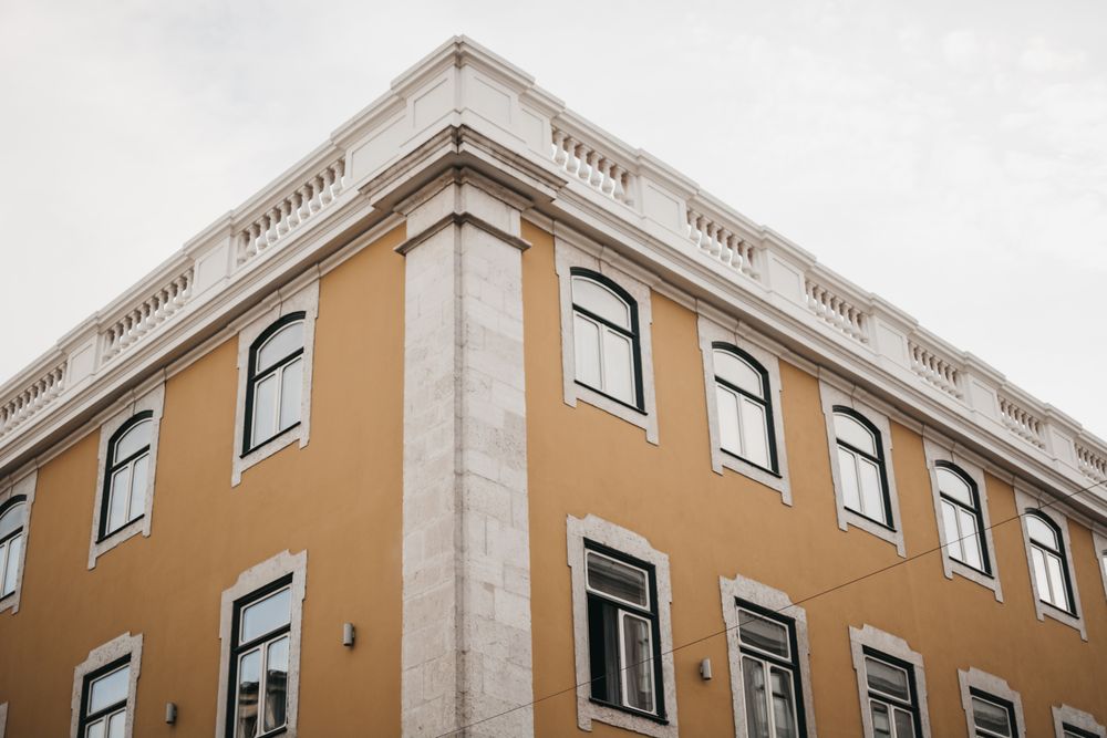 Corner of building against cloudy sky
