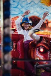 Cheerful girl riding mechanical bull