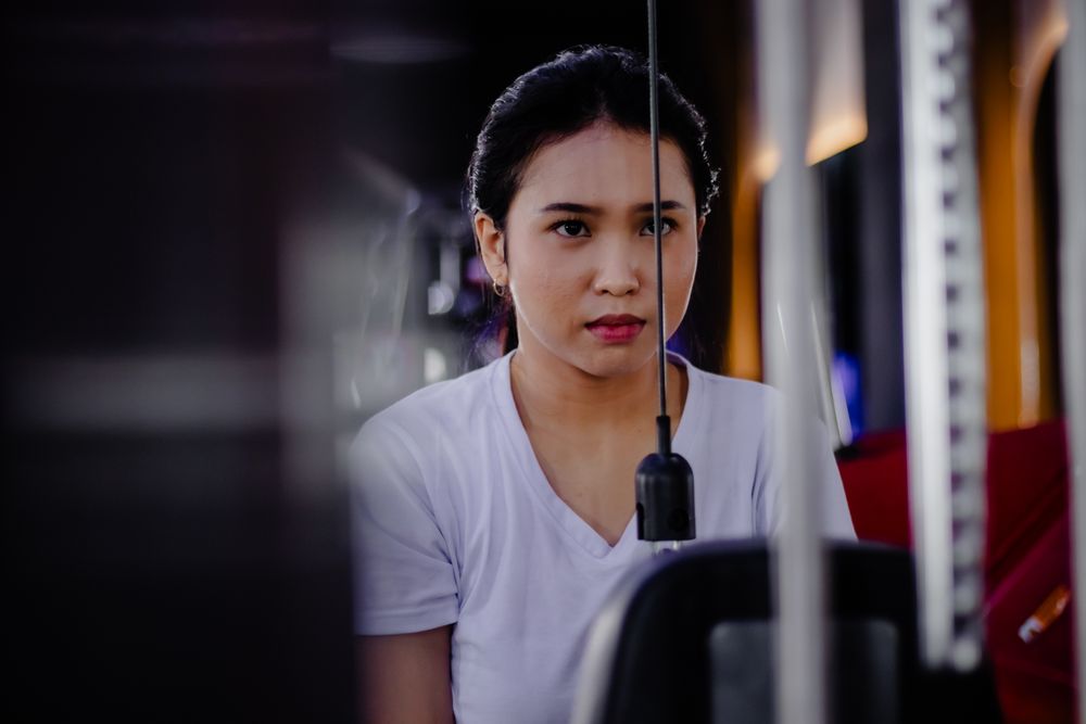 Focused young woman exercising at the gym on fitness equipment