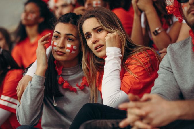 England female fans expressing disappointment while watching match in stadium