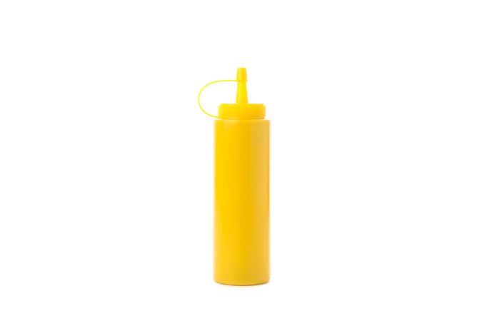 Yellow mustard bottle isolated on plain background