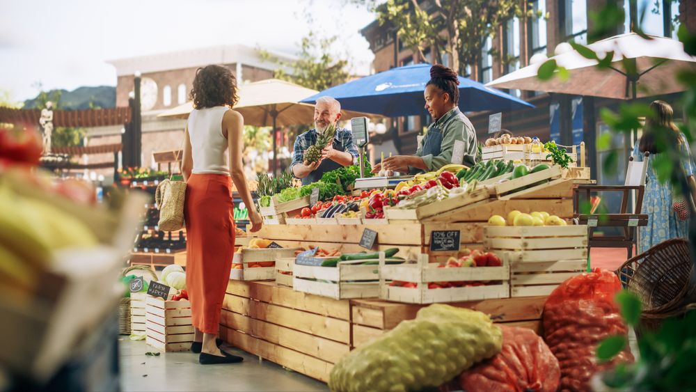 Successful Adults Managing Small Business Farm Stall at a City Square Market