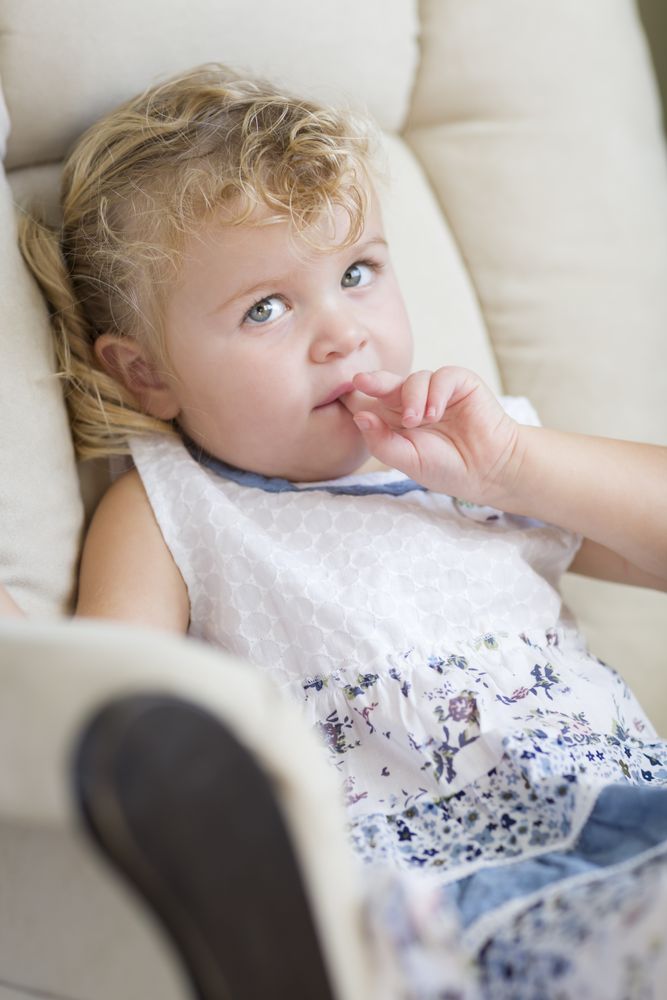 Cute Blonde and Blue Eyed Little Girl in Chair