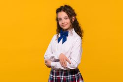 Girl with arms crossed, smiling confidently