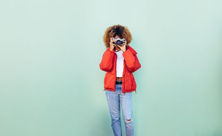 Woman holding a camera to her face taking a photo