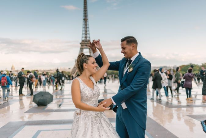 Happy newlyweds in wedding clothing dancing together