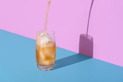 Cold tea with ice cubes in bright light