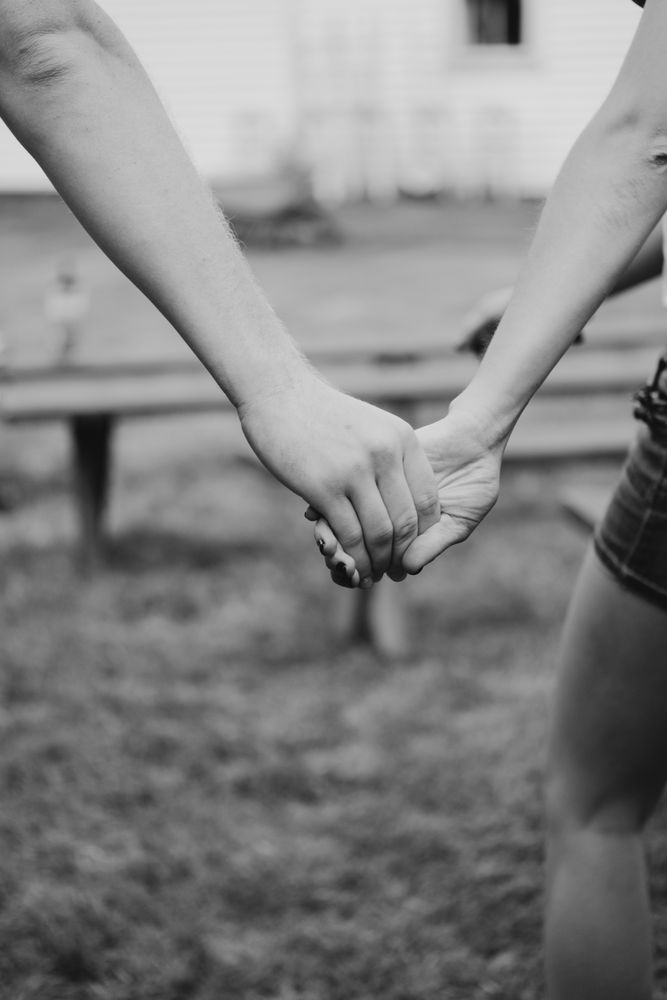 Cropped image of two holding hands