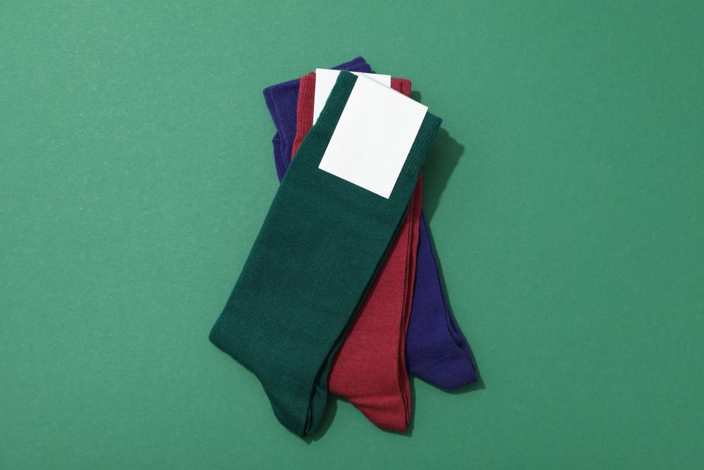 Multicolored high socks on a green background.