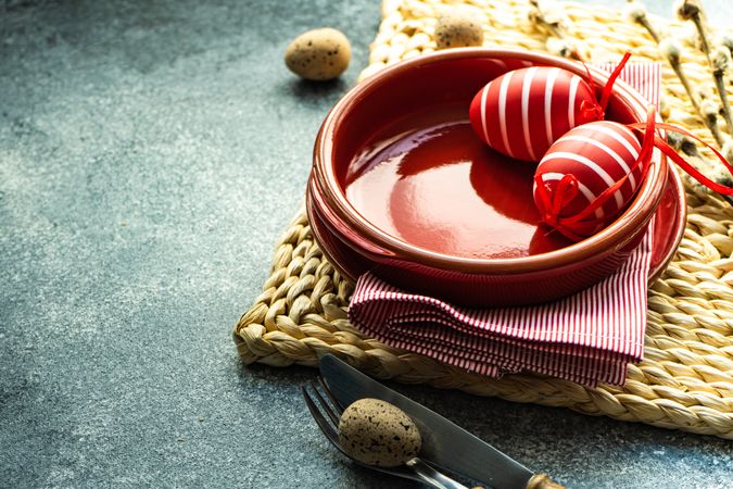 Easter holiday table setting with red decorative eggs
