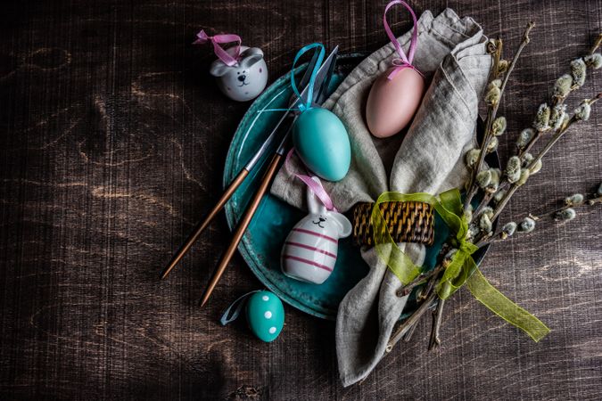 Top view of Easter table setting with decorative eggs and pussy willow