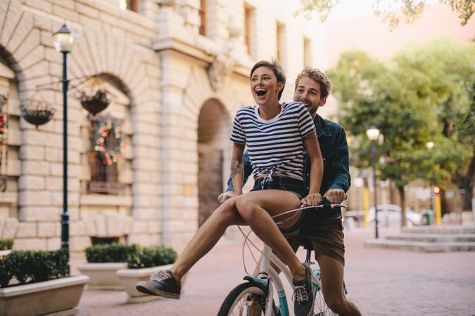 Couple enjoying on a bicycle in the city