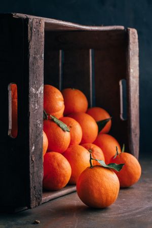 Fresh oranges in an old wooden box