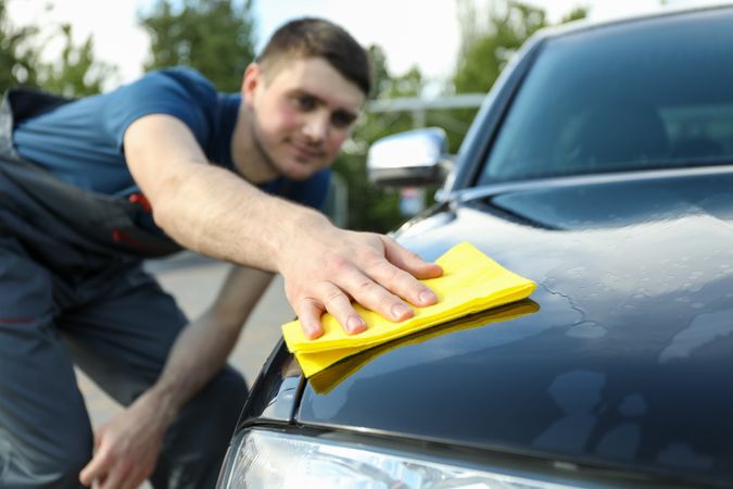 A man rubs a car. Car wash. Clear car concept