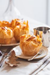 Galaktoboureko pastries on table with syrup dispenser