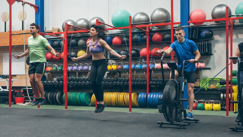 Athletes doing air bike and skipping rope