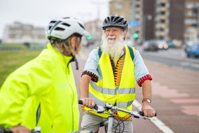 Happy older people with bikes stopped and talking