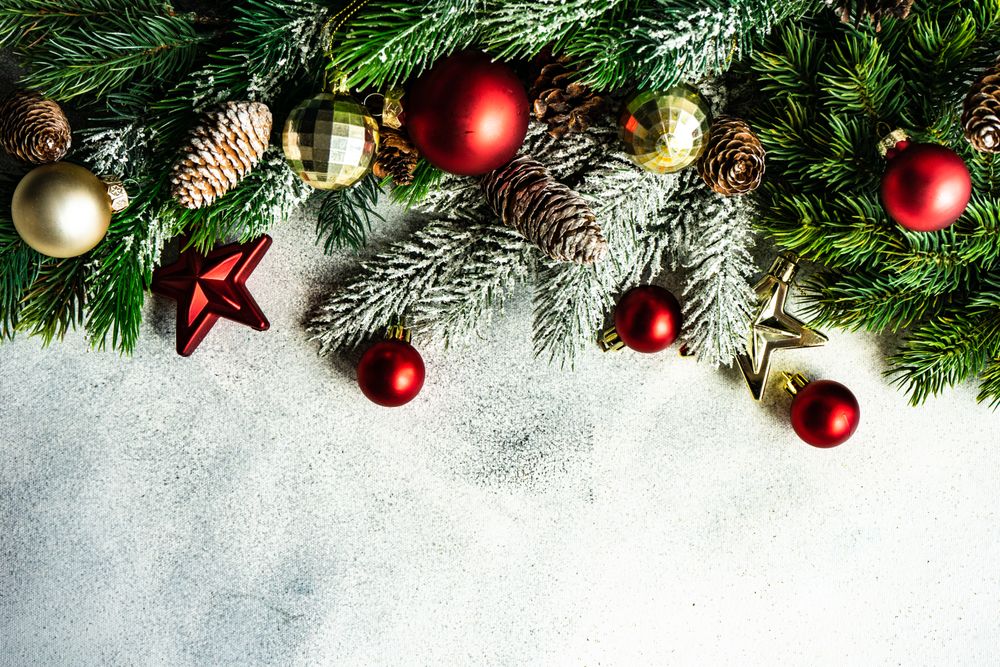 Christmas frame concept with pine branch and red & gold baubles