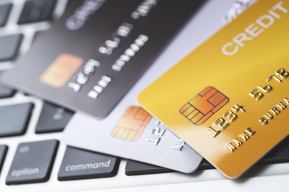 Assorted Credit Cards Placed on Laptop Keyboard for Online Payments