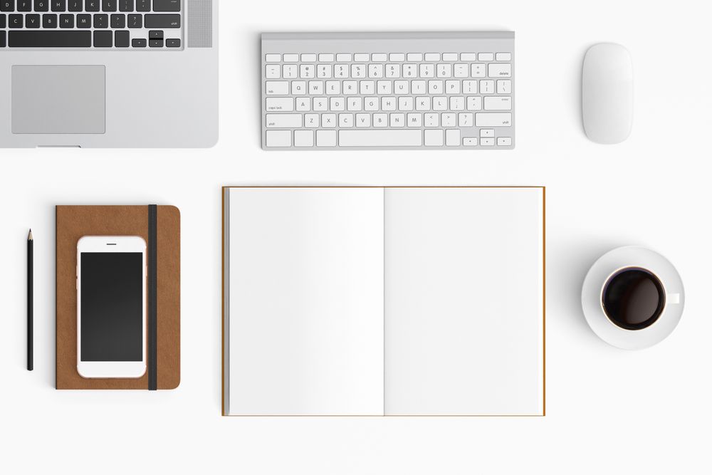 Modern workspace with coffee cup, smartphone, paper, notebook, tablet and laptop copy space