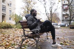 Young Black Man Explaining During a Video Call in the Park with a Laptop