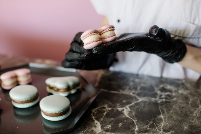 Person holding heart shaped macaron