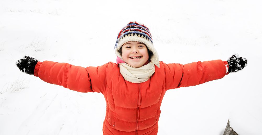 Playful child having fun in the snow