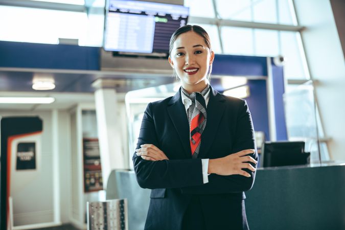 Portrait of a happy young woman working at airport