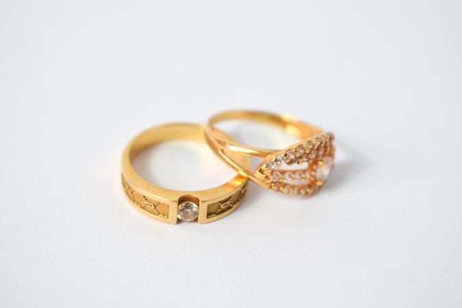 Two wedding diamond rings together on plain table