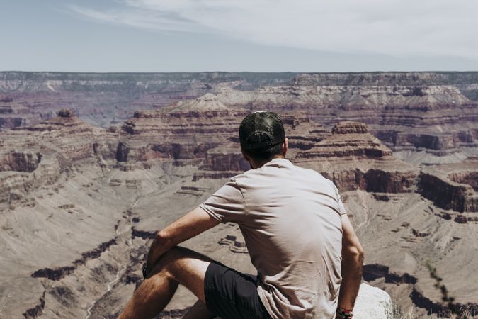Tourist gazing while standing on edge of picturesque canyon