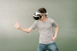 Young teenager with virtual reality glasses outdoors