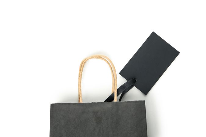 Paper bag with tag isolated on blank background