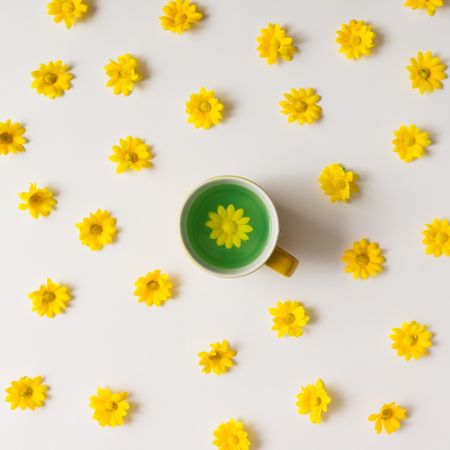 Green tea surrounded by yellow flowers pattern