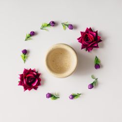 Flowers arranged in circle with coffee mug