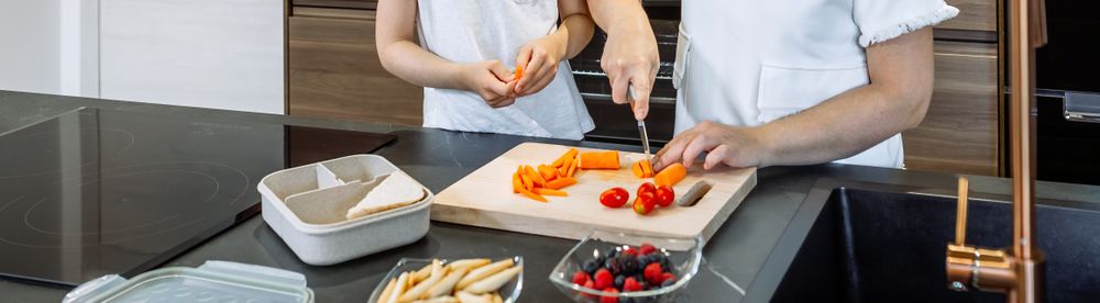 Mother preparing healthy snack for her daughter for school