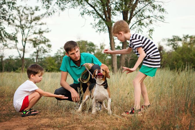 Father and two sons train dog