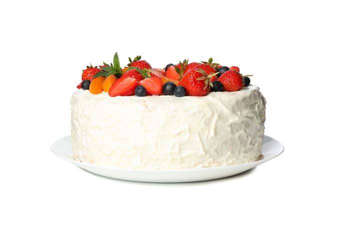 Plate with berry cream cake isolated on blank background
