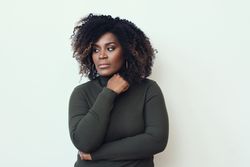 Black woman deep in thought with her hand to her chin