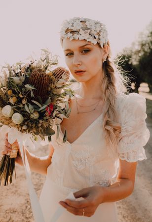 Woman in dress with flower bouquet