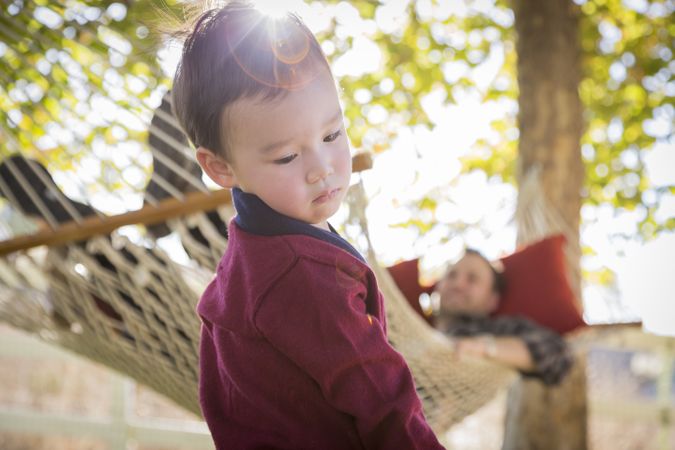 Boy Having Fun While Parent Watches From Behind