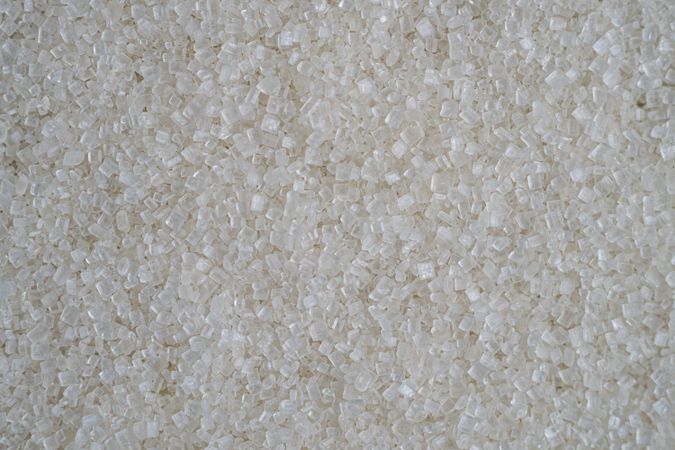 Flatlay of scattered granulated sugar